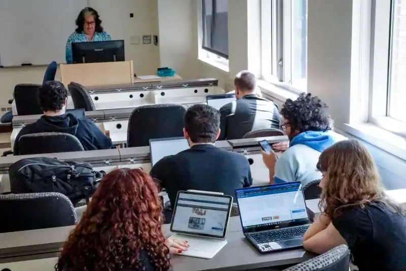 Students working on laptops in a classroom